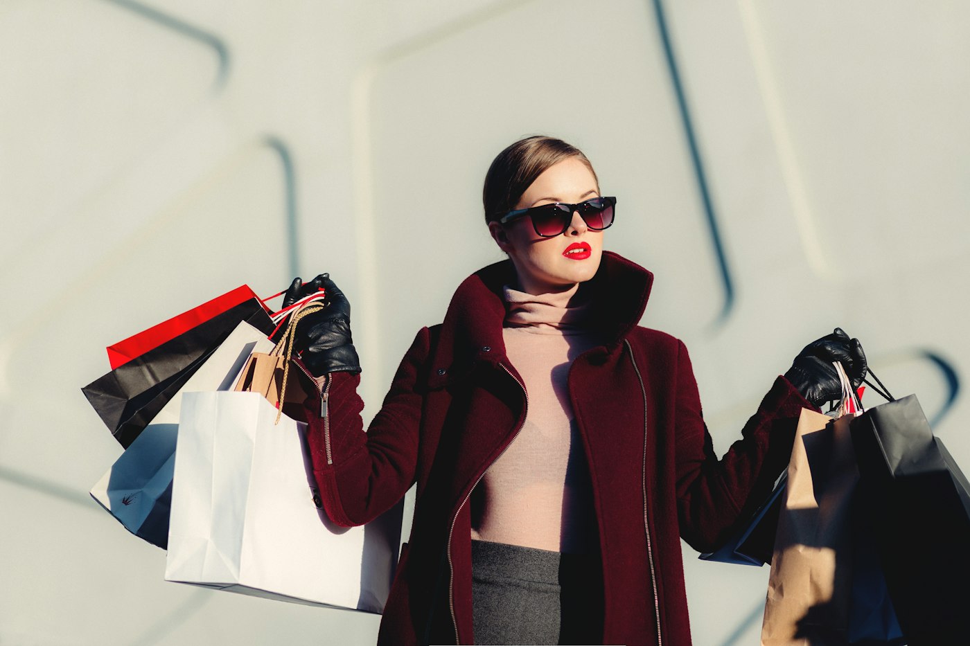 A stylish shopper carrying bags on a day out